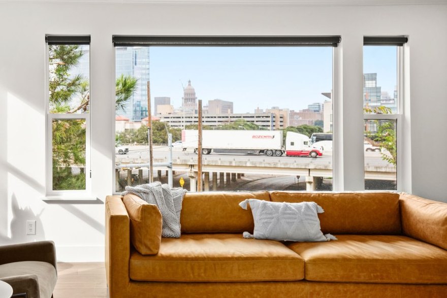 Living room of a luxury vacation rental managed by STR Management, with a view of the Texas Capitol through the window