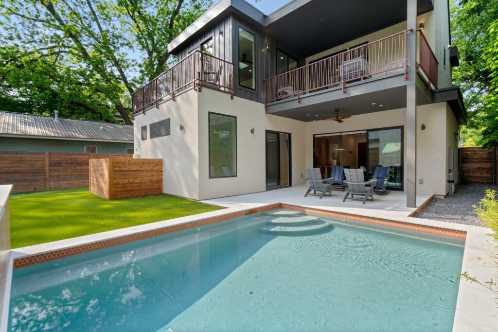 Backyard pool and modern two-story exterior of a luxury vacation rental managed by STR Management in East Austin